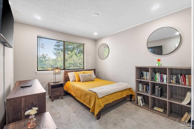 carpeted bedroom featuring ornamental molding and a textured ceiling