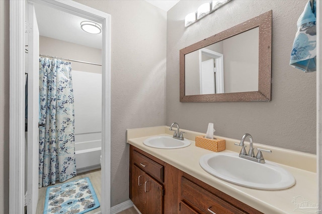 bathroom featuring shower / bath combination with curtain and vanity