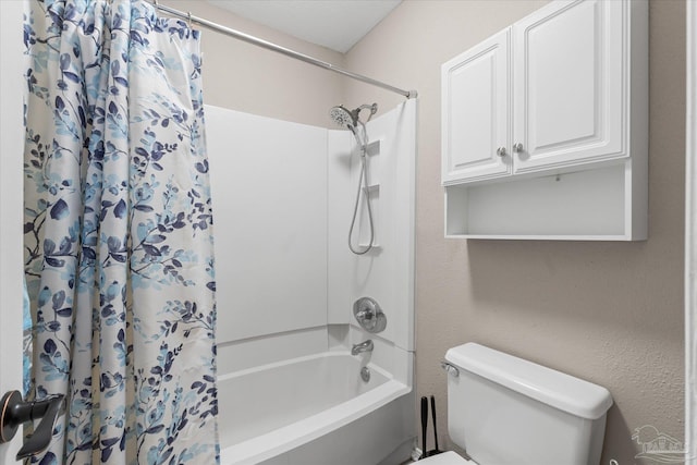 bathroom featuring shower / tub combo and toilet