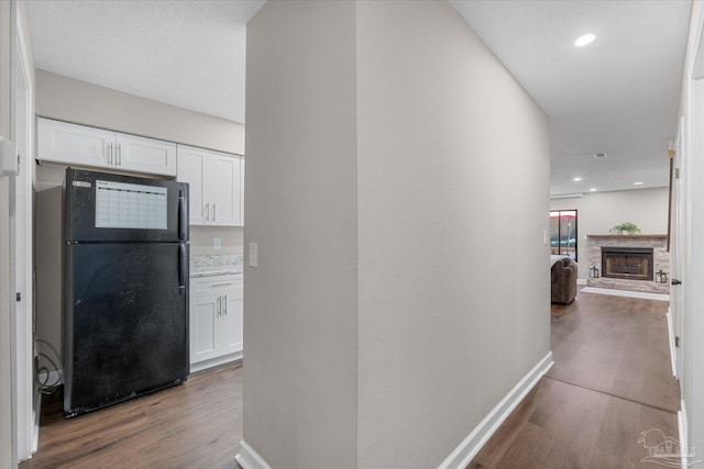 hallway with hardwood / wood-style floors