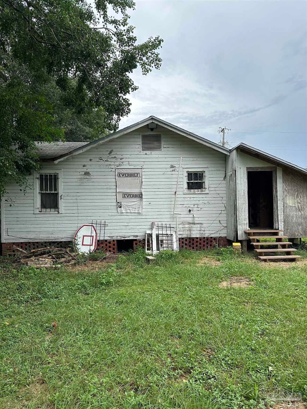 back of property with a lawn