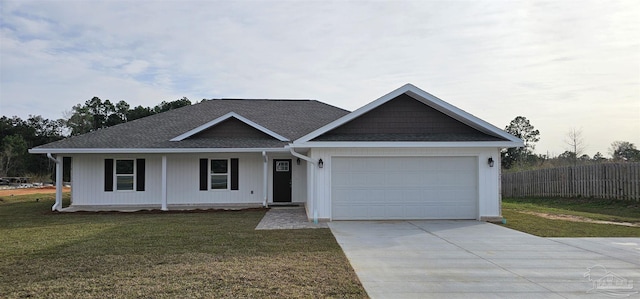 view of front of property featuring a garage and a front lawn