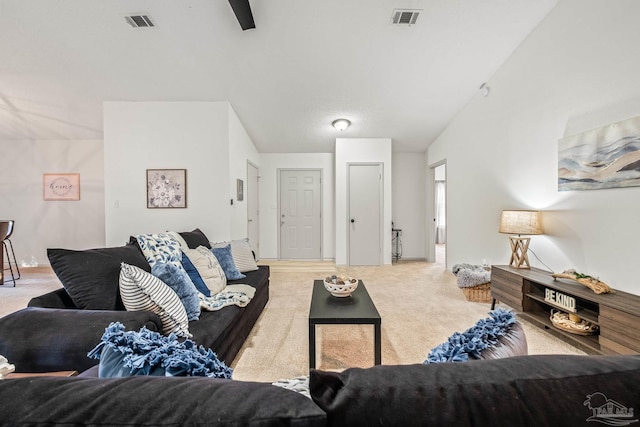 carpeted living room with lofted ceiling