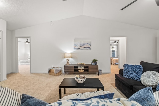 living room with light carpet, vaulted ceiling, and ceiling fan