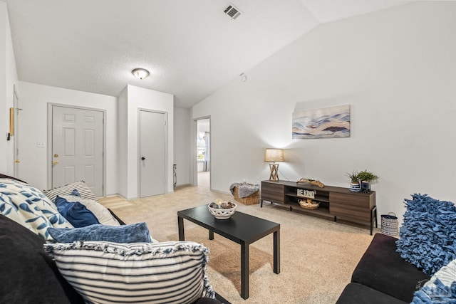 carpeted living room with vaulted ceiling