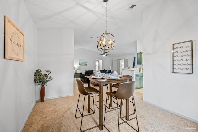 carpeted dining area featuring ceiling fan and vaulted ceiling