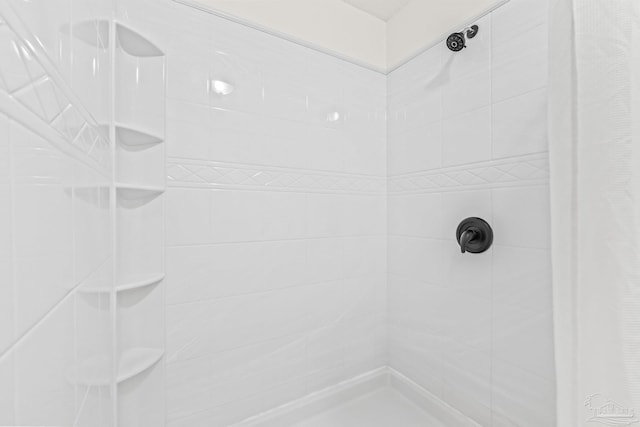 bathroom with tiled shower