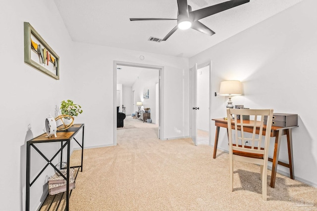 carpeted office featuring ceiling fan