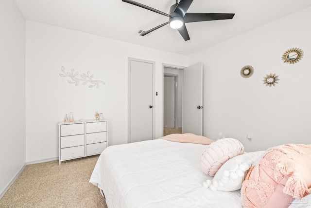 bedroom with ceiling fan and light colored carpet