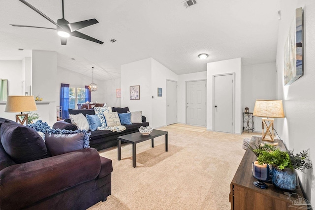 living room featuring ceiling fan with notable chandelier, light colored carpet, a textured ceiling, and vaulted ceiling