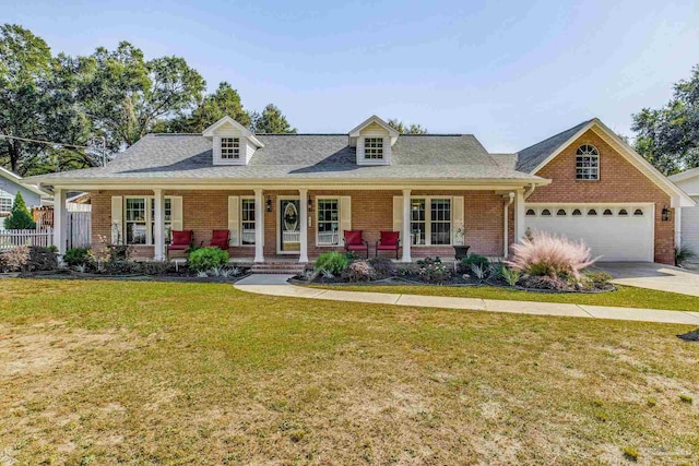 cape cod home featuring covered porch and a front lawn