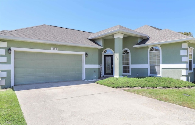 1200 Willowood Ln, Gulf Breeze, FL 32563 - ranch-style house featuring concrete driveway, roof with shingles, stucco siding, and an attached garage