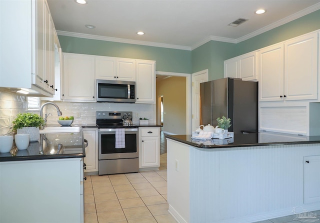 1200 Willowood Ln, Gulf Breeze, FL 32563 - kitchen with white cabinets, dark countertops, visible vents, and appliances with stainless steel finishes
