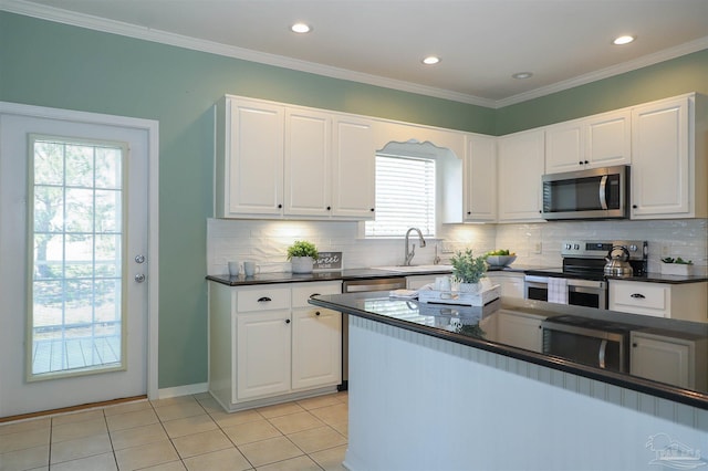 1200 Willowood Ln, Gulf Breeze, FL 32563 - kitchen with dark countertops, white cabinetry, and appliances with stainless steel finishes