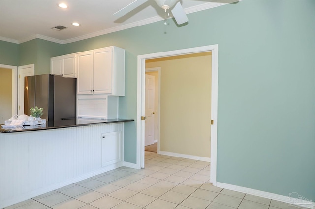 1200 Willowood Ln, Gulf Breeze, FL 32563 - kitchen with ornamental molding, white cabinetry, a ceiling fan, freestanding refrigerator, and dark countertops