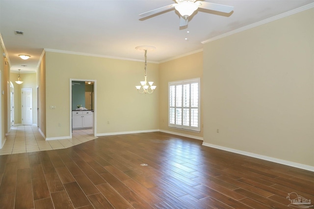 1200 Willowood Ln, Gulf Breeze, FL 32563 - spare room featuring visible vents, baseboards, ornamental molding, wood finished floors, and ceiling fan with notable chandelier