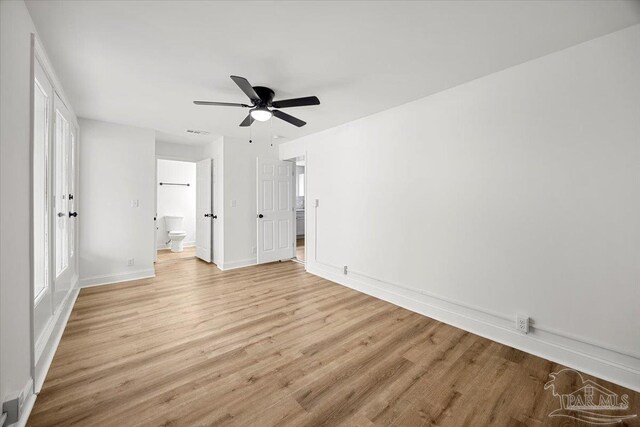 unfurnished bedroom with light hardwood / wood-style floors, ensuite bath, and ceiling fan