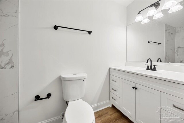 bathroom featuring vanity, toilet, and hardwood / wood-style floors