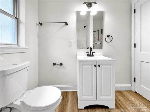 bathroom with vanity, hardwood / wood-style flooring, and toilet