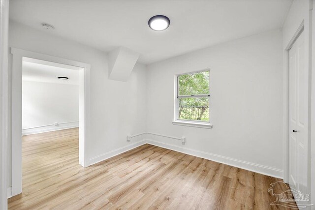 unfurnished bedroom with a closet and light hardwood / wood-style floors