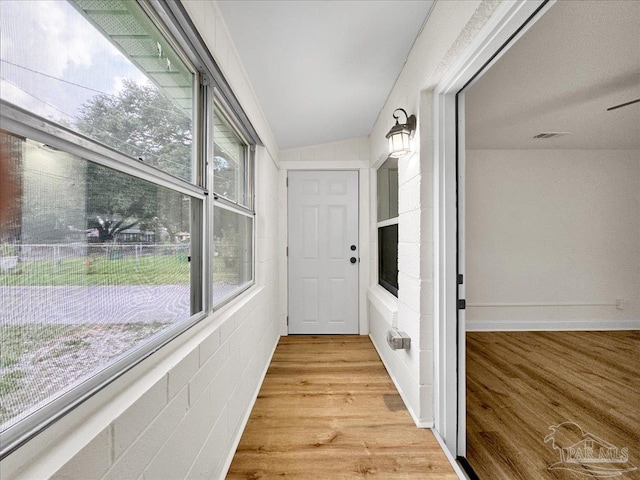 interior space featuring light hardwood / wood-style flooring and lofted ceiling