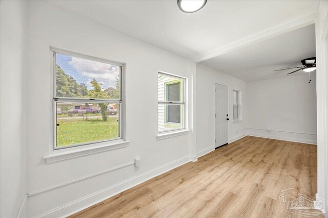 foyer entrance with ceiling fan and light wood-type flooring