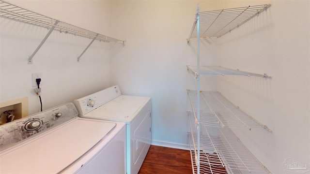 laundry room featuring laundry area, separate washer and dryer, wood finished floors, and baseboards