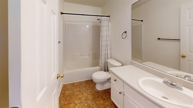 bathroom featuring shower / tub combo, stone finish floor, vanity, and toilet