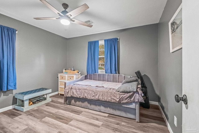 bedroom featuring ceiling fan and light hardwood / wood-style floors