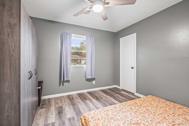 unfurnished bedroom with ceiling fan and light hardwood / wood-style floors