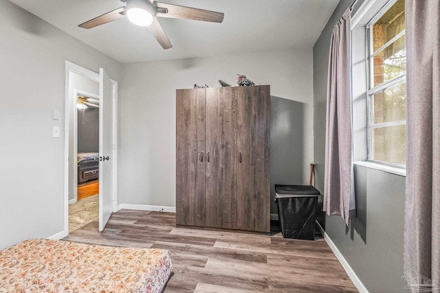 bedroom with ceiling fan and wood-type flooring