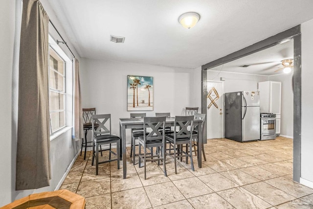 dining room with ceiling fan and plenty of natural light