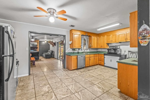 kitchen featuring ceiling fan, sink, stainless steel appliances, and ornamental molding