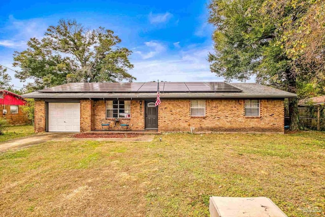 single story home with solar panels, a garage, and a front lawn