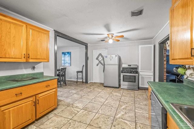 kitchen featuring appliances with stainless steel finishes, ceiling fan, crown molding, and sink