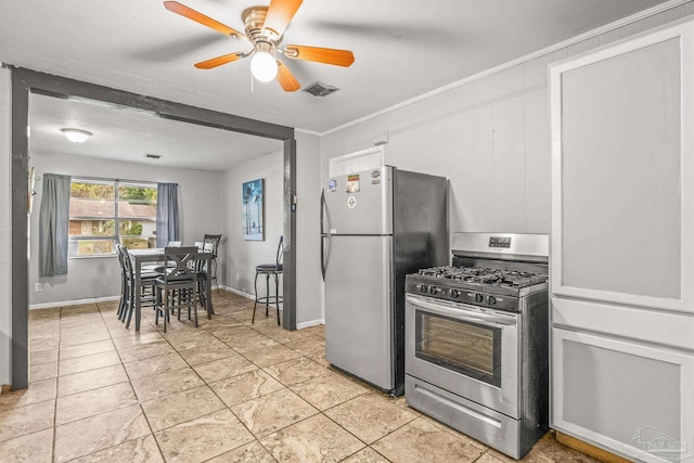 kitchen with appliances with stainless steel finishes, ornamental molding, a textured ceiling, ceiling fan, and light tile patterned flooring