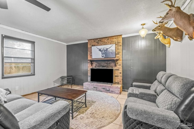 living room featuring light tile patterned floors, a textured ceiling, a brick fireplace, and crown molding