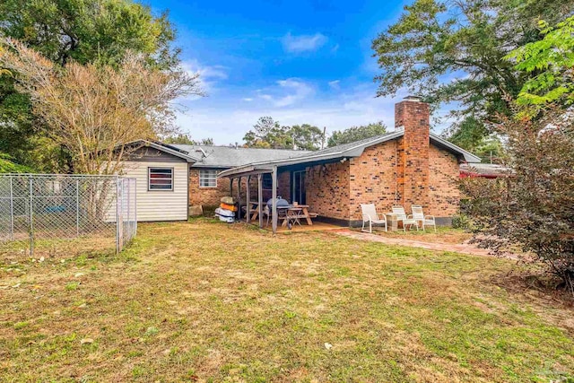 back of house with a lawn