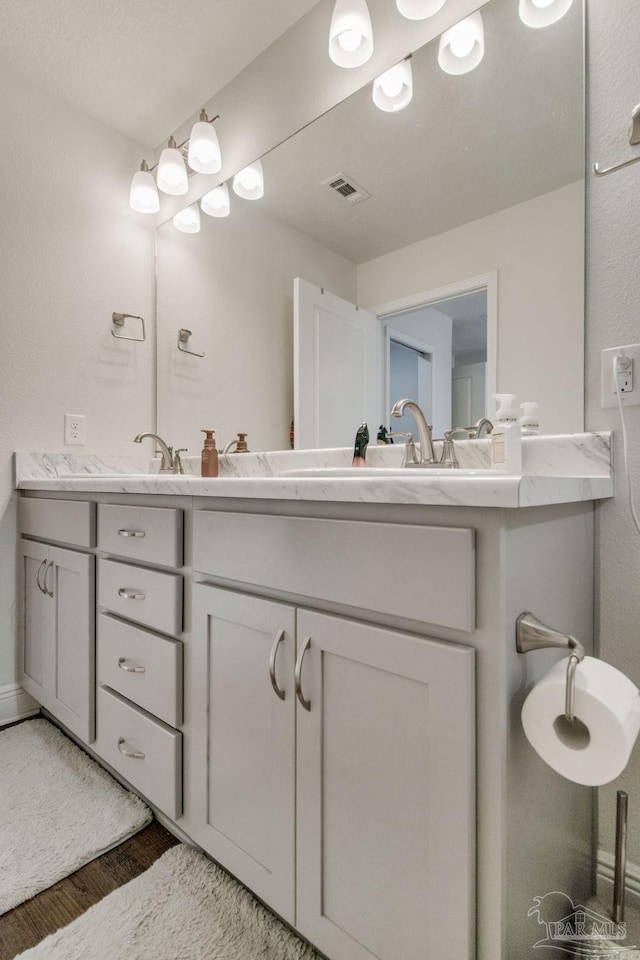 bathroom with vanity and hardwood / wood-style flooring