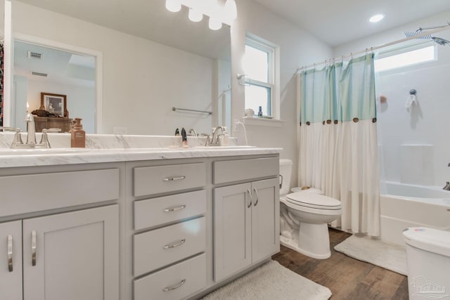 full bathroom featuring vanity, hardwood / wood-style flooring, toilet, and shower / bathtub combination with curtain