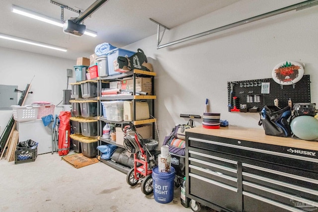 garage featuring electric panel and a garage door opener