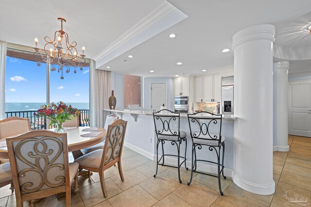 721 Pensacola Beach Blvd Unit 702, Pensacola Beach, FL 32561 - dining room featuring crown molding, a chandelier, recessed lighting, light tile patterned flooring, and ornate columns