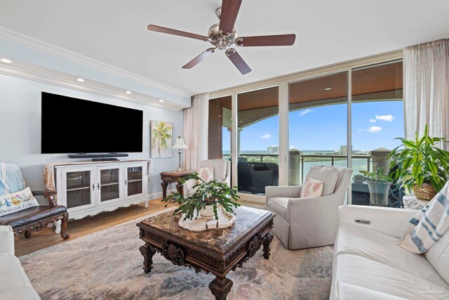 721 Pensacola Beach Blvd Unit 702, Pensacola Beach, FL 32561 - living area featuring a ceiling fan, ornamental molding, and wood finished floors