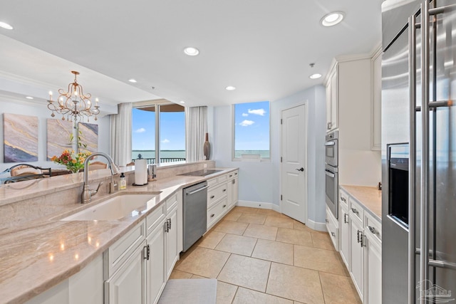 721 Pensacola Beach Blvd Unit 702, Pensacola Beach, FL 32561 - kitchen featuring stainless steel appliances, white cabinetry, recessed lighting, light stone counters, and light tile patterned flooring