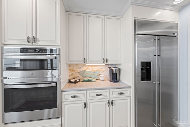 721 Pensacola Beach Blvd Unit 702, Pensacola Beach, FL 32561 - kitchen with stainless steel appliances, decorative backsplash, and white cabinetry