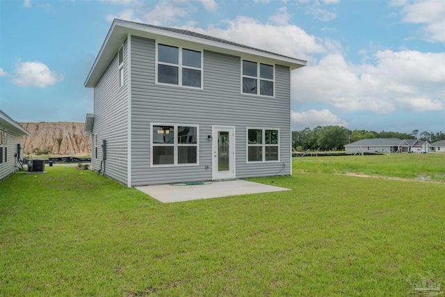 rear view of house with a yard and a patio area