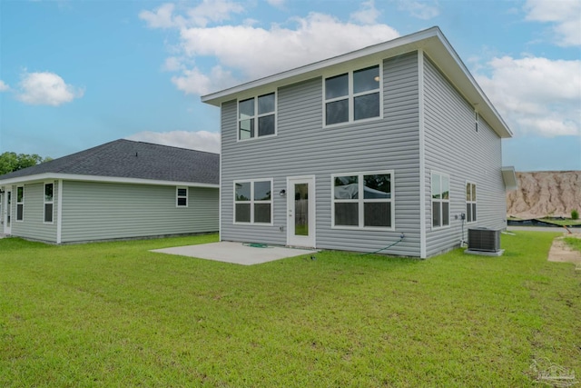 rear view of property with a patio, a yard, and central air condition unit