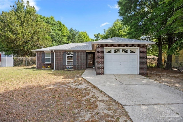 single story home with driveway, a front yard, an attached garage, fence, and brick siding