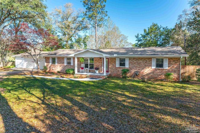 4900 Shell Rd, Milton, FL 32583 - ranch-style home with a front yard, fence, brick siding, and a garage