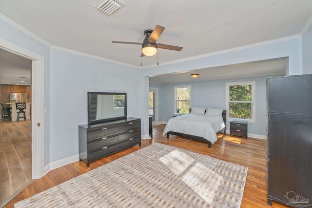 4900 Shell Rd, Milton, FL 32583 - bedroom with crown molding, wood finished floors, visible vents, and baseboards